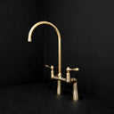 Unlacquered brass bridge faucet – installed over farmhouse sink