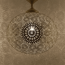 Boho brass hanging lamp with geometric pierced design lit up in room – Brass For Homes