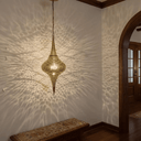 Close-up of intricate pierced brass pendant light design – Brass For Homes