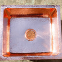 Hammered copper kitchen island sink – drain detail and basin interior – Brass For Homes