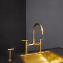 Mykonos brass bridge faucet with sprayer – installed in farmhouse kitchen