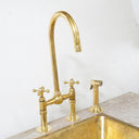 Brass bridge faucet with pull-down sprayer – installed in kitchen