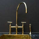 Unlacquered brass 3-hole bridge kitchen faucet with lever handles – front view