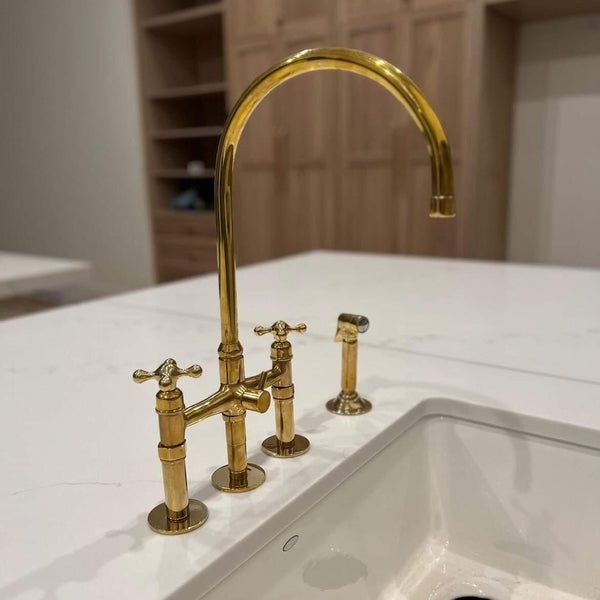 Unlacquered brass bridge kitchen faucet with side sprayer – front view
