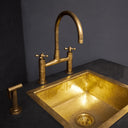 Unlacquered brass kitchen bridge faucet with sprayer and cross handles – front view